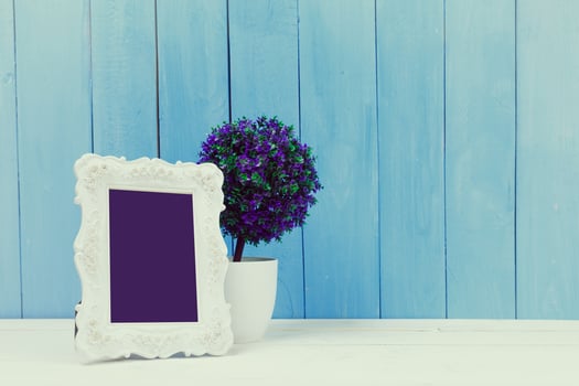 Wooden items of home decor close up on blue wooden background photo
