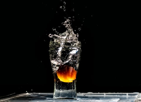 A watermelon is being splashed into a glass photo