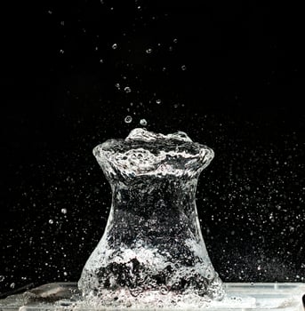 A vase with water splashing out of it photo