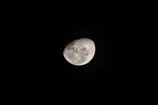 A moon in the dark sky with a black background photo