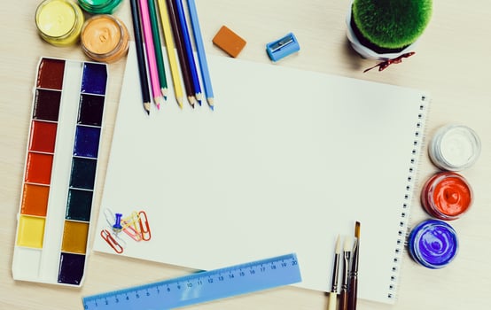 Creative workspace with art supplies, blank paper, and vibrant colors set for artistic projects photo