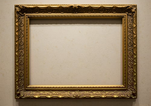 Old antique gold frame on white wall background. Vintage picture frame. photo