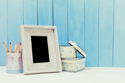 Wooden items of home decor close up on blue wooden background photo