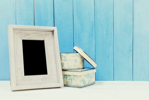 Wooden items of home decor close up on blue wooden background photo
