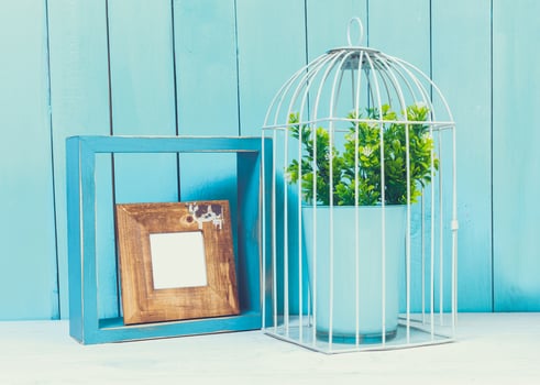 Home decor items on blue wooden background photo