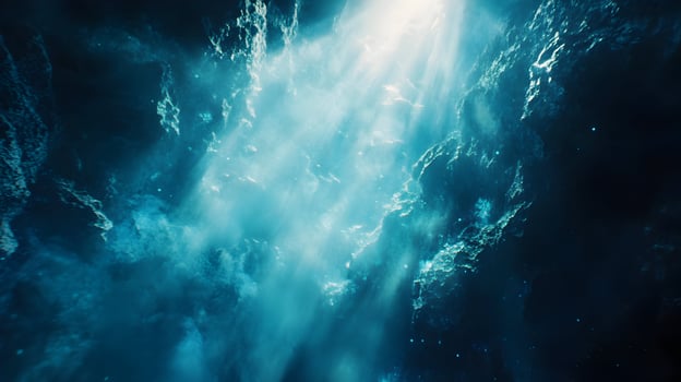 Dramatic Underwater Cave Scene with Light Rays Penetrating Turquoise Water Surface photo