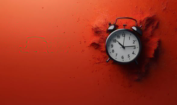 Black alarm clock is half-covered by red sand on a red background, symbolizing time running out photo