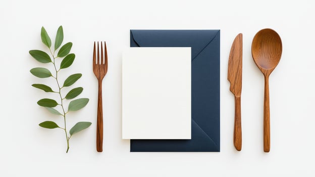 A white card with a fork, knife, and spoon on top of it photo