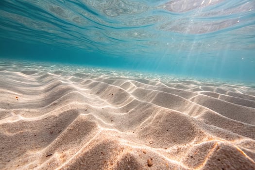 Underwater view of sand and water photo