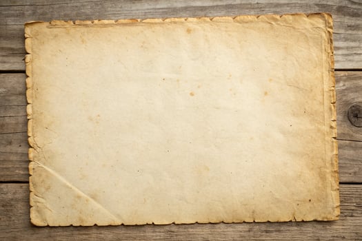 Old paper on wooden background photo