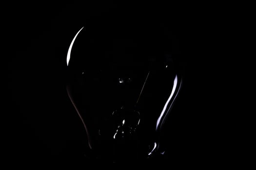 Close-up of electrical bulb on black background photo