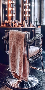Microfiber towel draped over a stylish barber chair in a salon photo