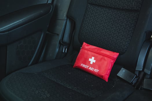 The Compact First Aid Kit conveniently located on the Car Seat serves as essential safety gear designed for various roadside emergencies that may arise during travel photo