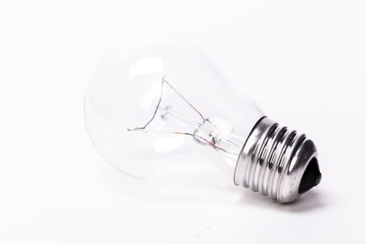 Close up of a light bulb on white background photo