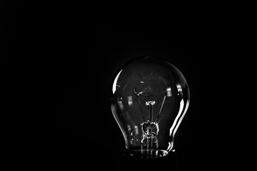 Close-up of electrical bulb on black background photo