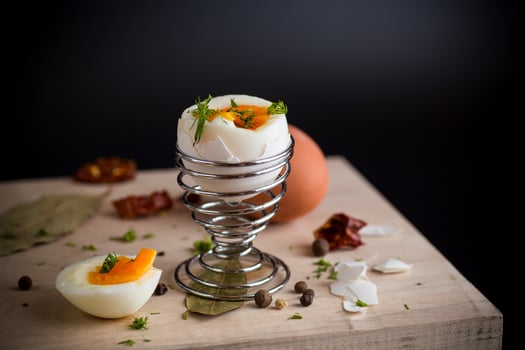 morning soft boiled egg for breakfast, isolated on black background photo