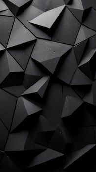 Abstract geometric patterns in a black three-dimensional design with sharp angles and varied textures in close-up view photo