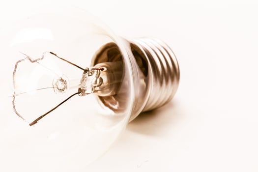 Close up of a light bulb on white background photo