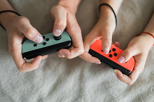 Woman and man playing on the game console. Holding hands gamepad, game controller photo