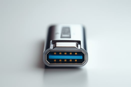 Close-up of a silver USB flash drive with blue accent, emphasizing its modern design and technology. photo