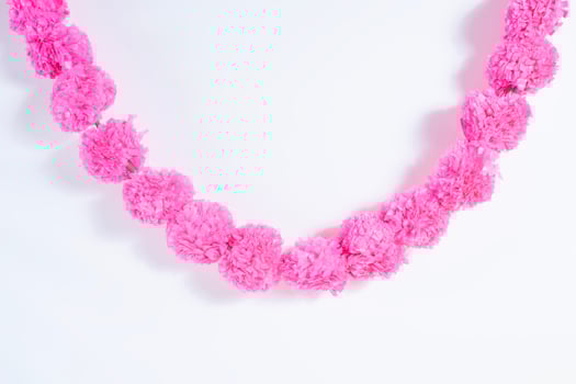 A pink flower necklace with a chain photo