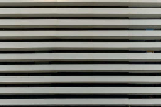 Modern architectural design showcases minimalist white horizontal slats in a contemporary building facade photo