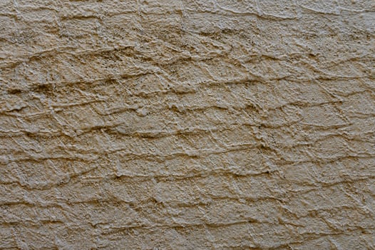 Textured wall brings rustic charm to urban environment during sunny afternoon photo