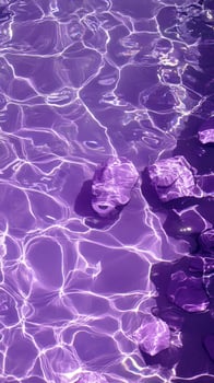 Purple Water with Submerged Rocks and Light Refraction photo