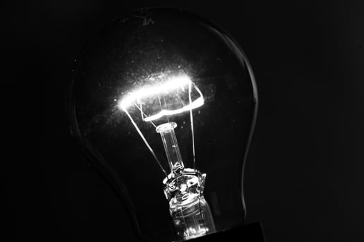 Close-up of electrical bulb on black background photo