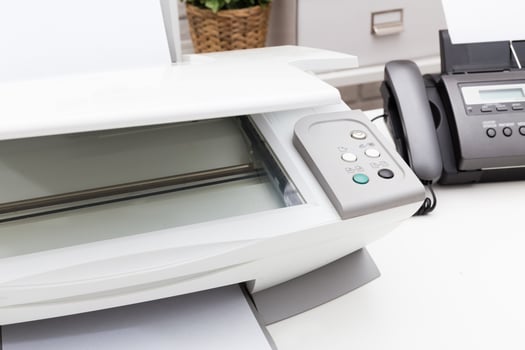 Printer and fax machine on office table photo