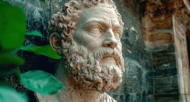 Marble bust of a bearded man in a garden setting photo