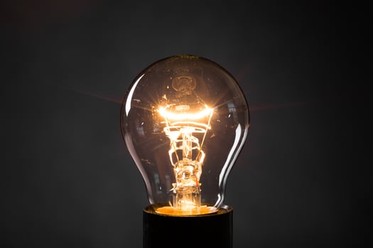 Close-up of electrical bulb on black background photo