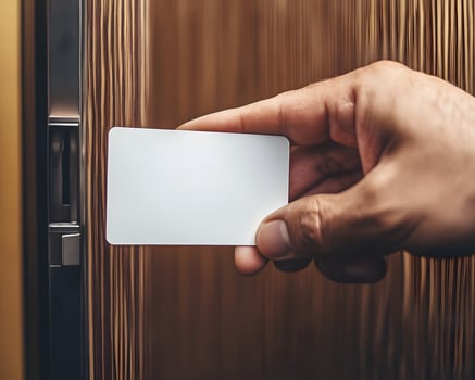 Hand Holding Blank Card at Door Lock photo
