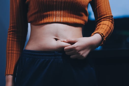 A woman with a large belly and a small tattoo photo