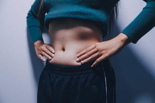 A woman with her hands on her stomach photo