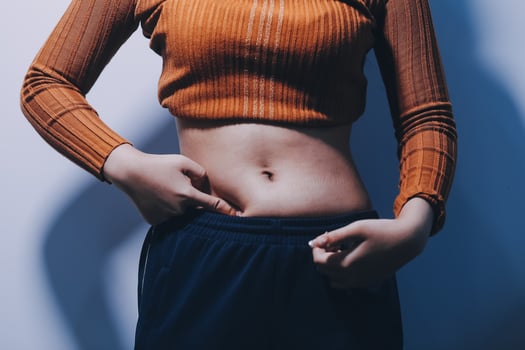 A woman with her hands on her stomach photo