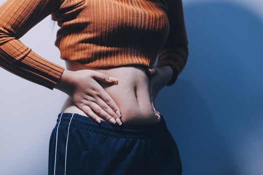 A woman with her hands on her stomach photo