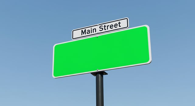 A green street sign with a white background photo