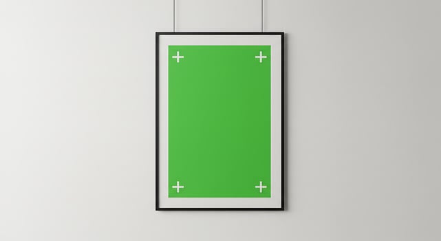 A green and white framed poster hanging on a wall photo