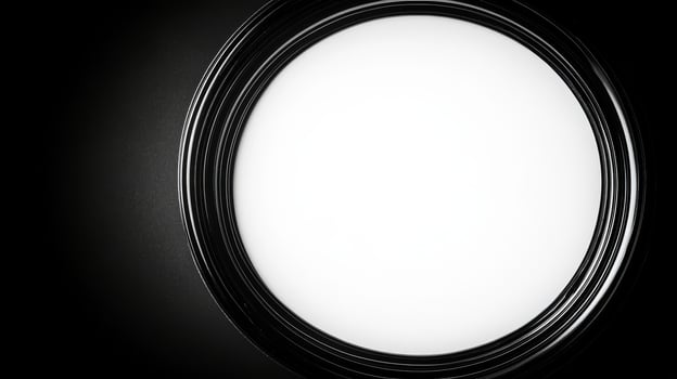 Circular light fixture casting a soft glow in a darkened room photo