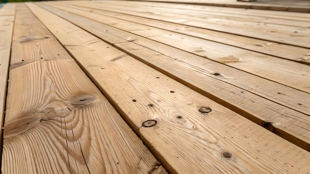 Rustic Light Brown Wooden Planks Showing Natural Grain and Knots Texture on a Timber Deck Surface photo