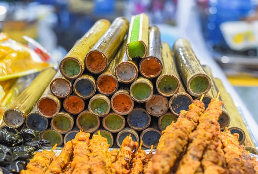 Colorful sticky rice in the bamboo in vietnamese night market photo