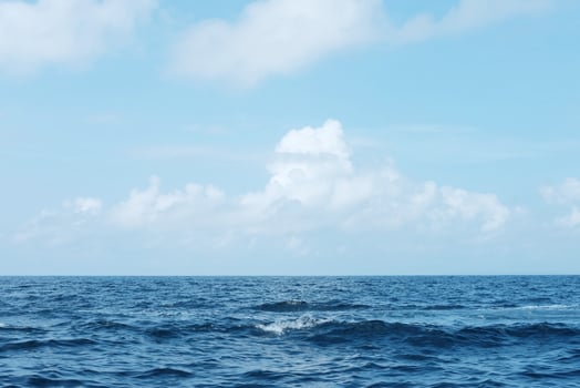 landscape of horizontal calm blue sea with wave and cloud and blue sky in bright day. Travel destination of ocean in Bali, Indonesia photo