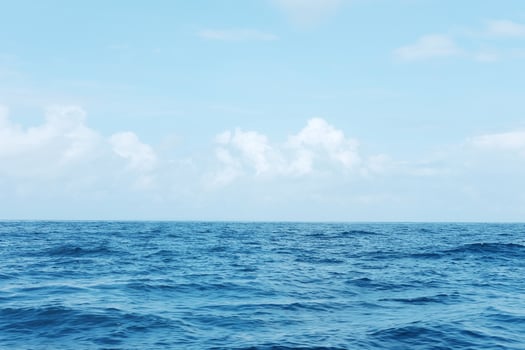 landscape of horizontal calm blue sea with wave and blue sky in bright day. Travel destination summer of ocean in Bali, Indonesia photo
