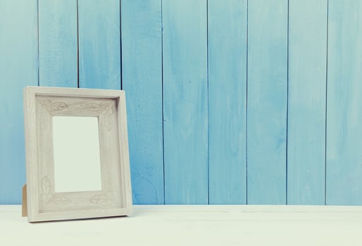 Wooden items of home decor close up on blue wooden background photo
