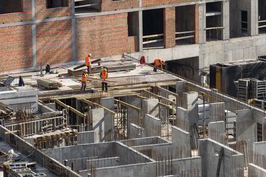 Construction worker Concrete pouring during commercial concreting floors of building in construction site and Civil Engineer or Construction engineer inspec work photo