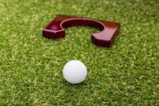 Indoor mini golf equipment set on green grass background photo