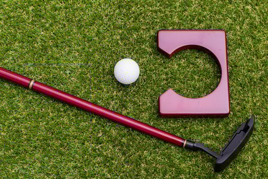 Mini golf equipment on grass close up photo
