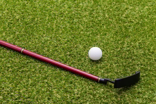 Mini golf equipment on grass close up photo