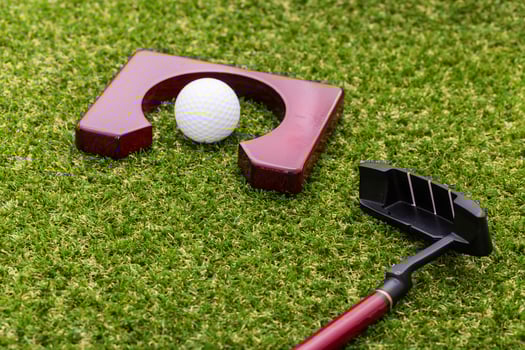 Indoor mini golf equipment set on green grass background photo